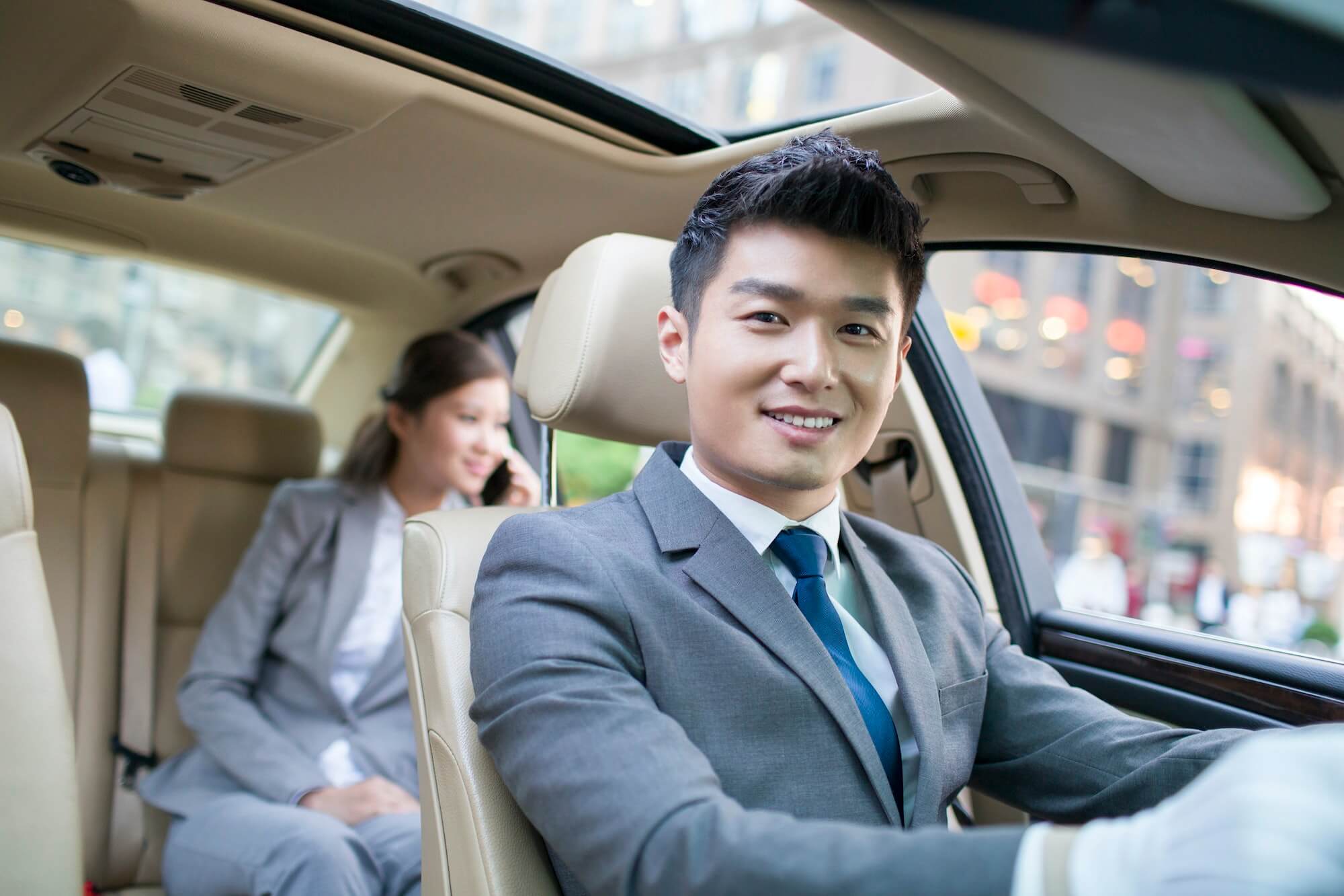 Chauffeur driving car for a businesswoman