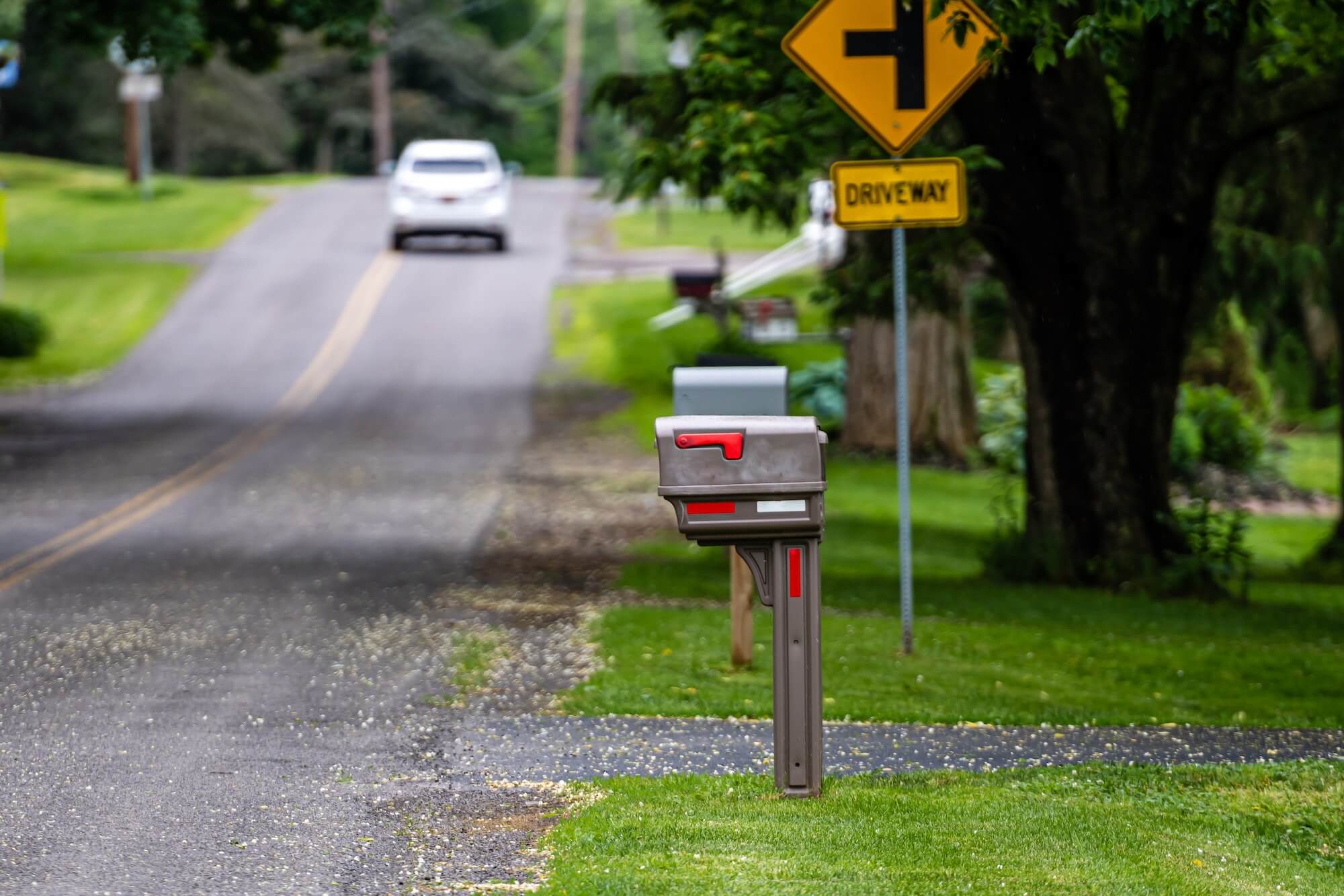 a traditional American mailbox on the side of a village road in Penfield, NY