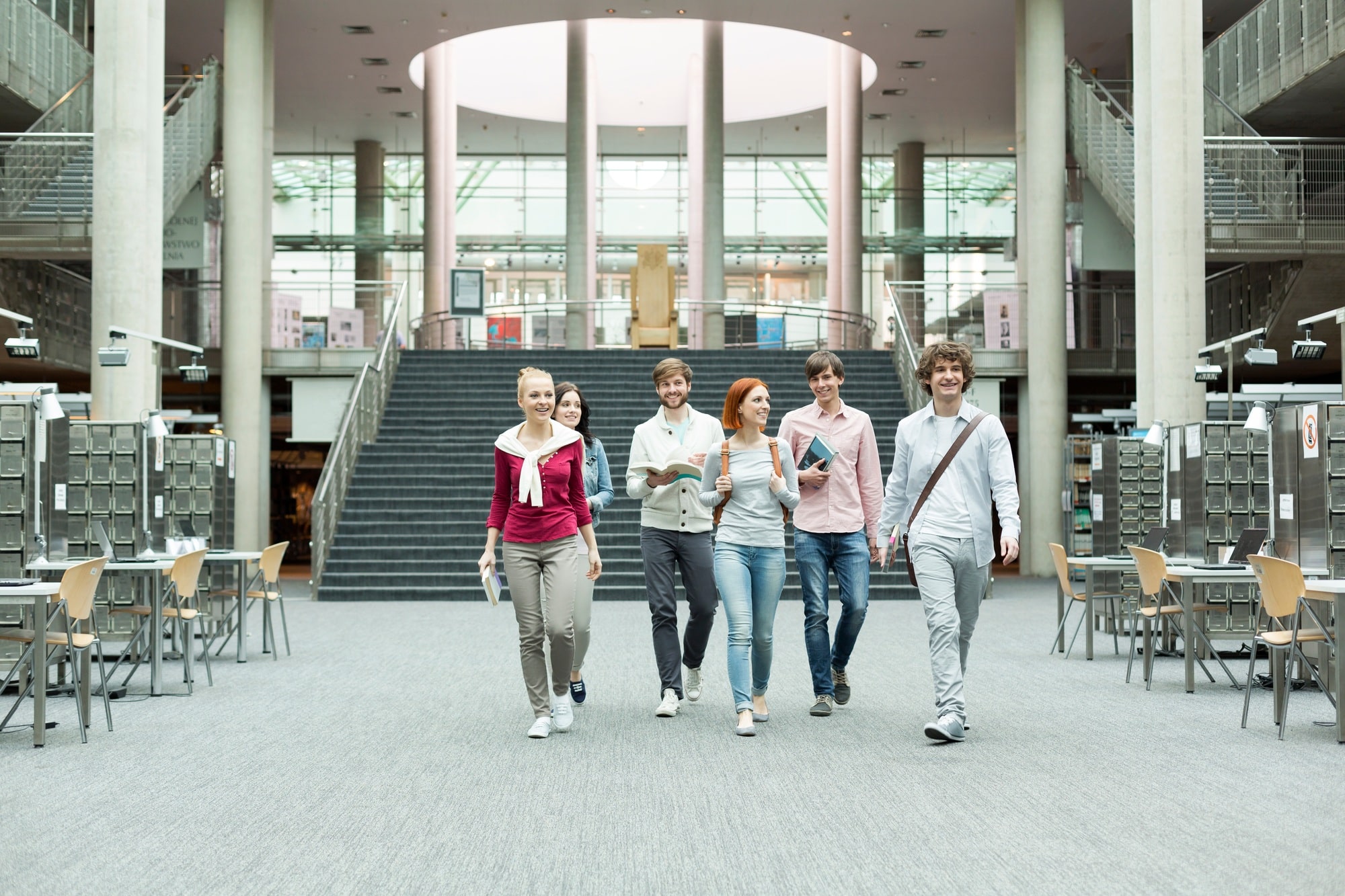 Group of students walking in a university library